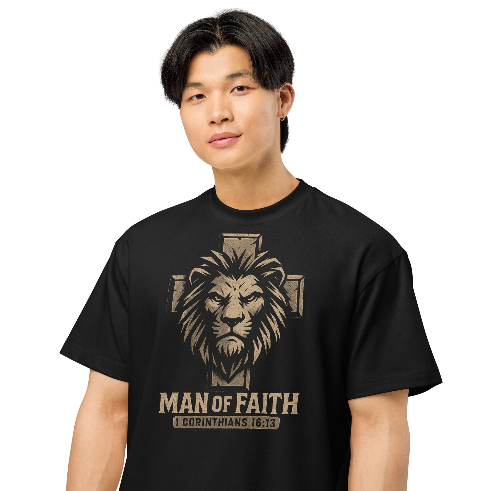 Black Cotton Heritage Men’s Box Tee with lion and cross graphic and text ‘Man of Faith – 1 Corinthians 16:13’ in bold Christian design.
