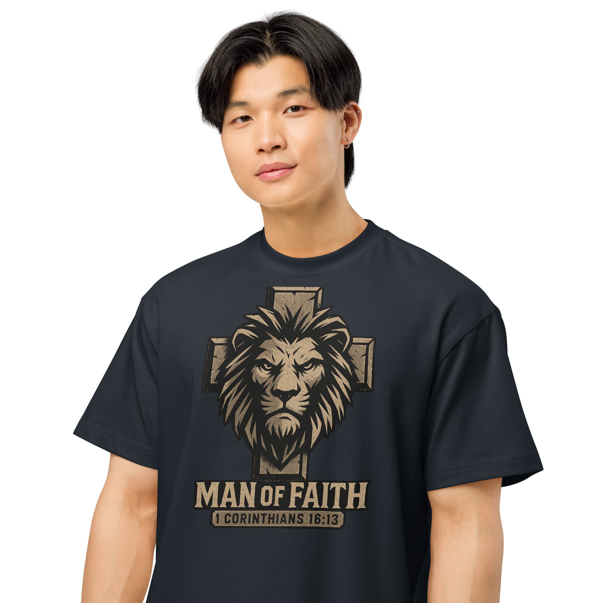 navy Cotton Heritage Men’s Box Tee with lion and cross graphic and text ‘Man of Faith – 1 Corinthians 16:13’ in bold Christian design.