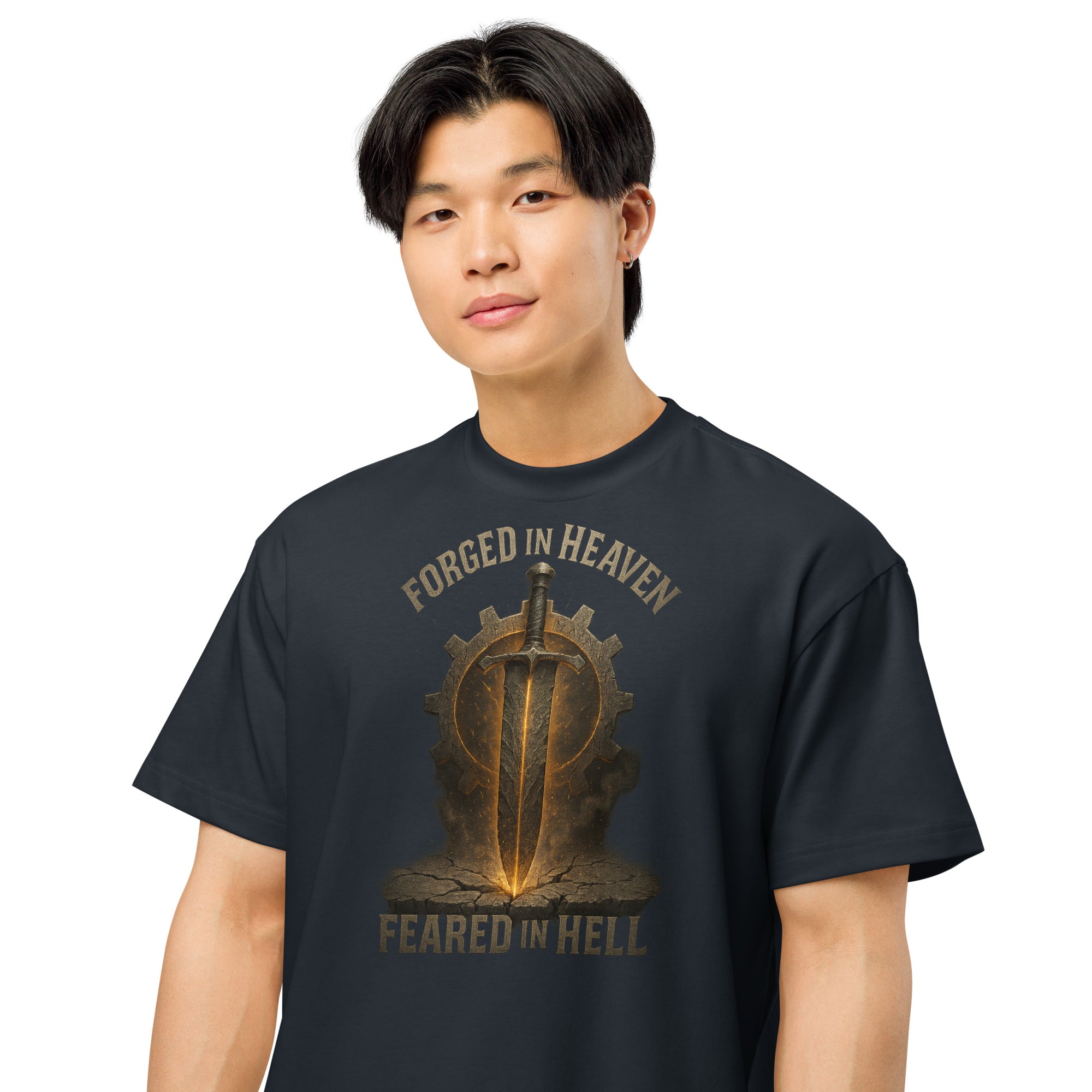NAVY men’s box tee with bold sword and gear graphic, featuring the words Forged in Heaven, Feared in Hell.