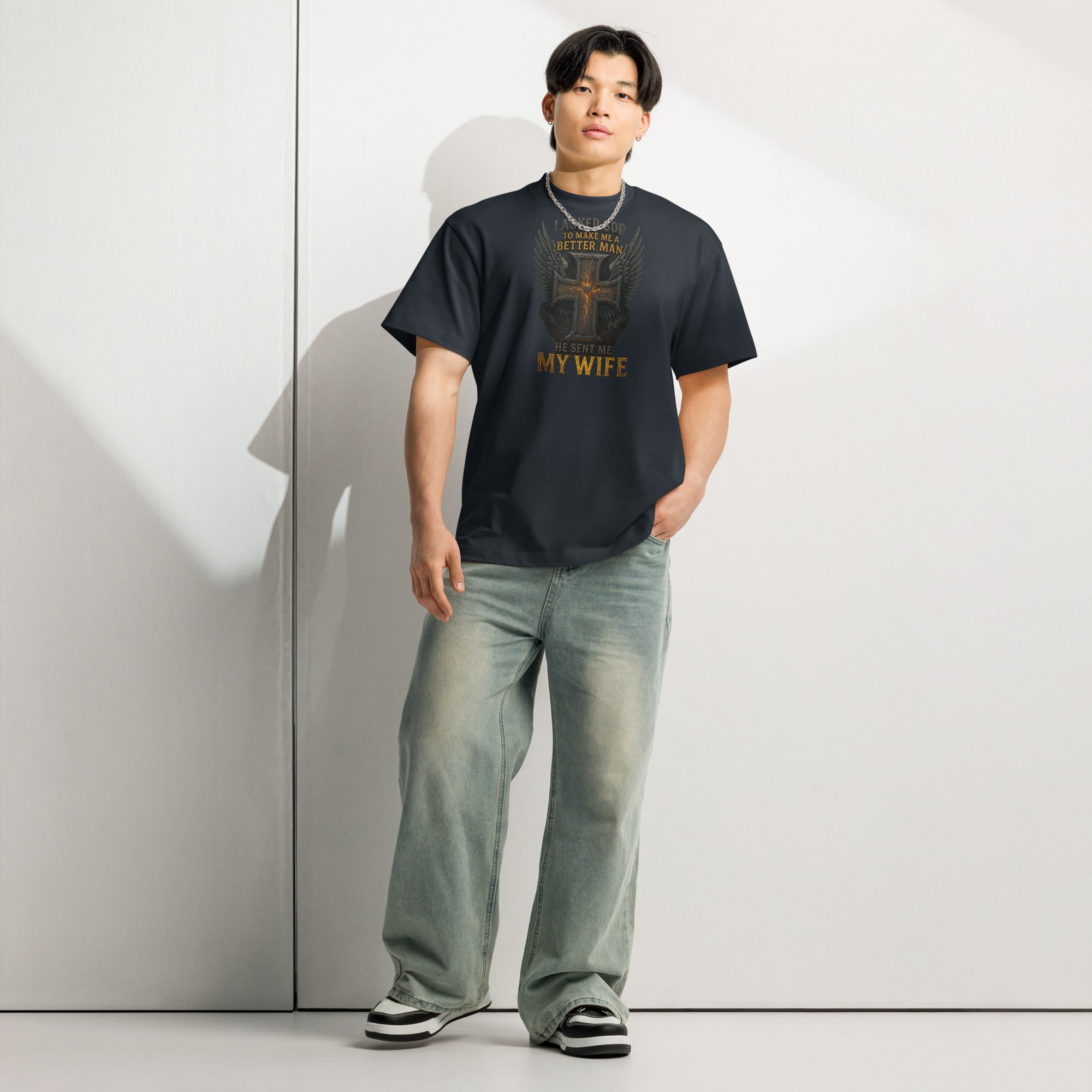 Navy men’s box tee with Christian graphic design of cross with wings and text ‘I asked God to make me a better man, He sent me my wife’ – faith-based marriage shirt.