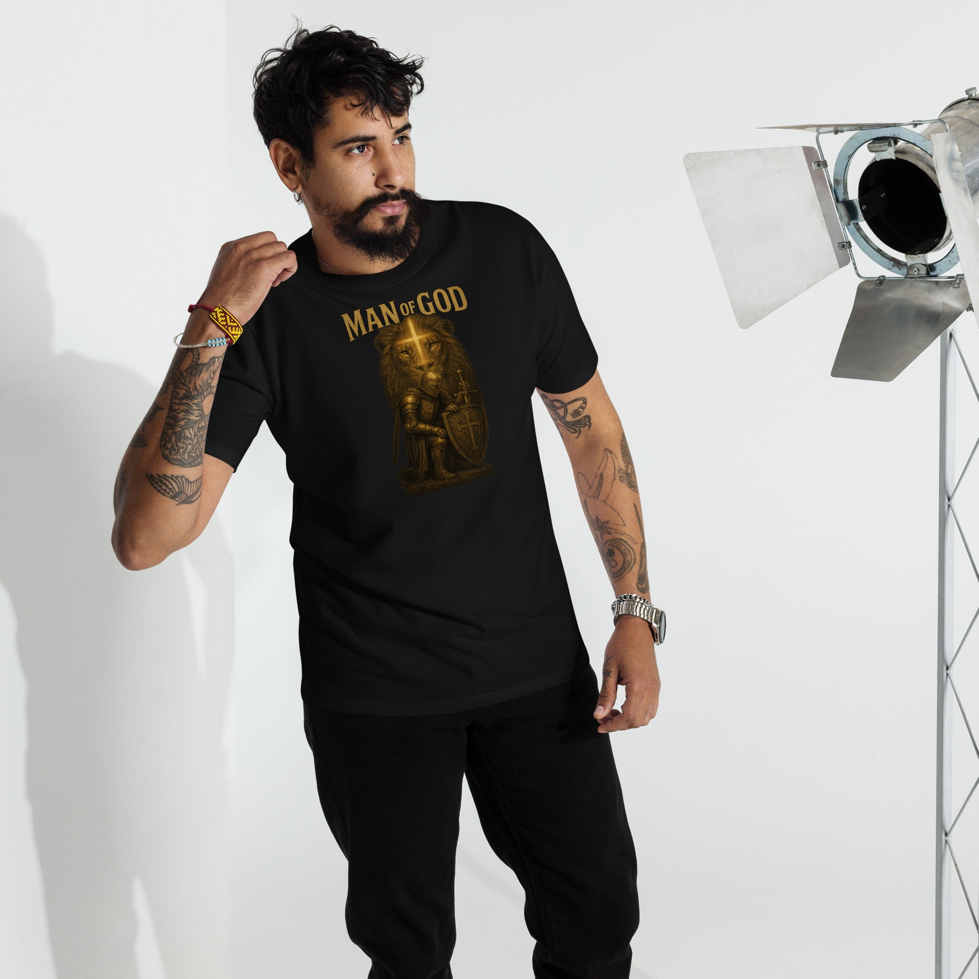 Man wearing Man of God t-shirt with bold lion and knight faith graphic in urban setting
