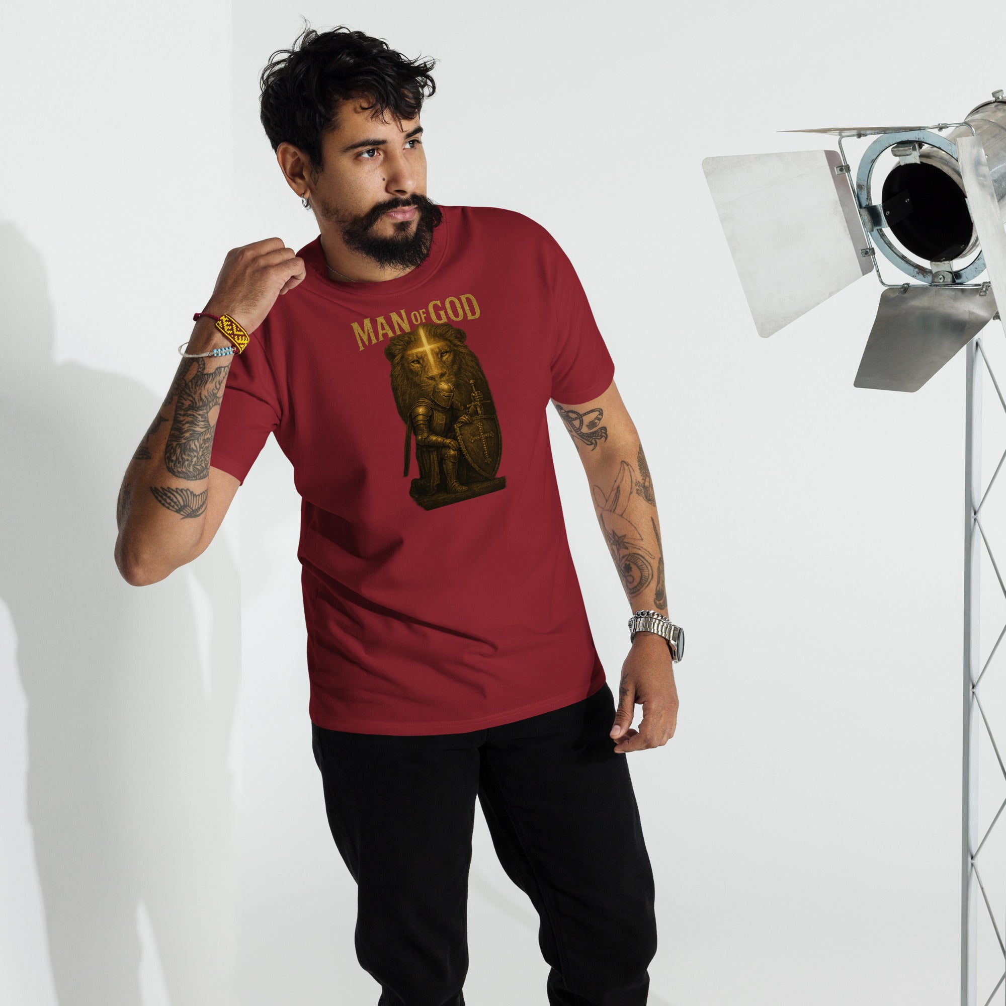 Man wearing Man of God t-shirt with bold lion and knight faith graphic in urban setting