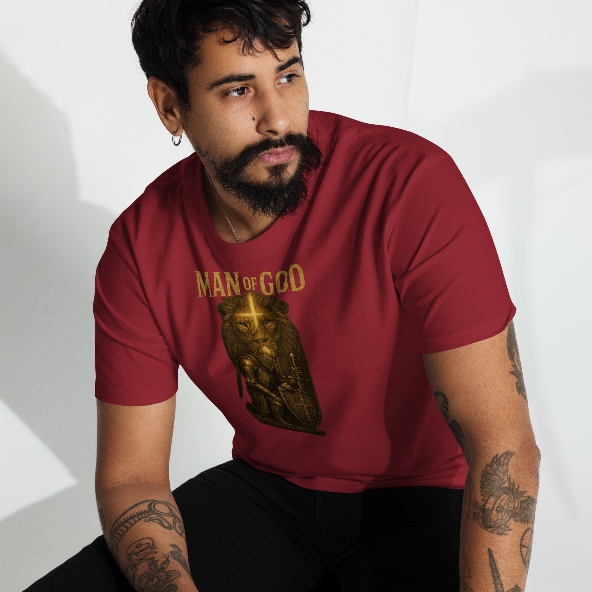 Man wearing Man of God t-shirt with bold lion and knight faith graphic in urban setting