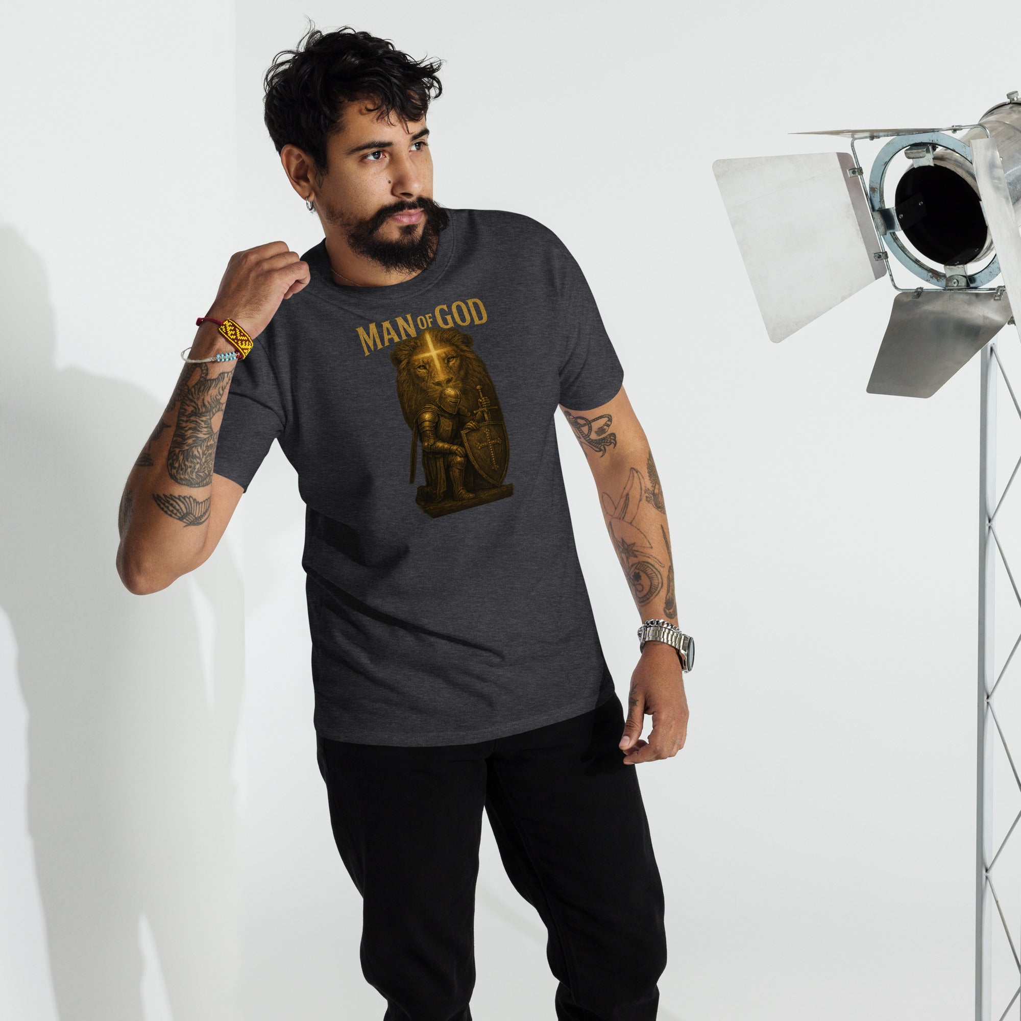 Man wearing Man of God t-shirt with bold lion and knight faith graphic in urban setting