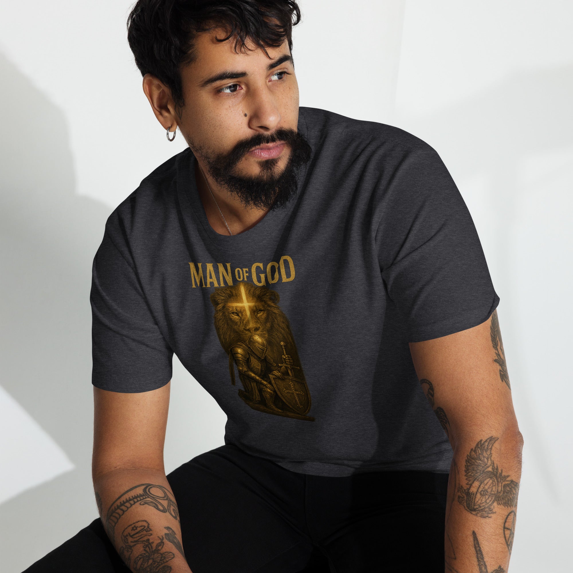 Man wearing Man of God t-shirt with bold lion and knight faith graphic in urban setting