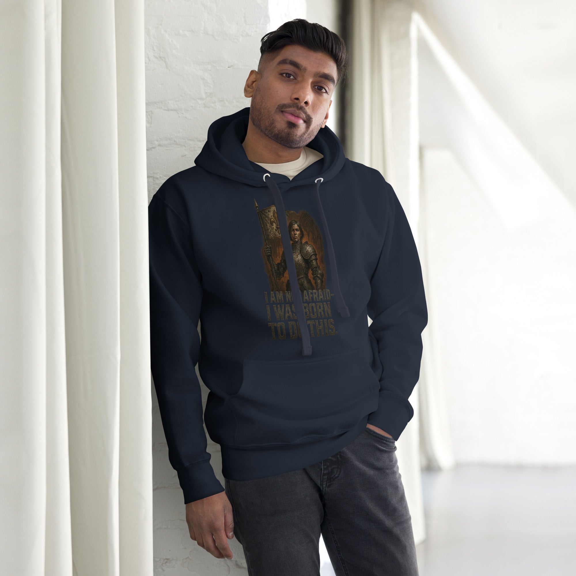 Navy Cotton Heritage premium hoodie featuring Joan of Arc warrior graphic with fleur-de-lis banner and the quote “I Am Not Afraid – I Was Born to Do This.”
